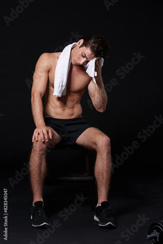 Fitness, sweat and towel with sports man in studio isolated on black background for fatigue. Burnout, exercise and exhausted with shirtless athlete or bodybuilder in dark for health and wellness