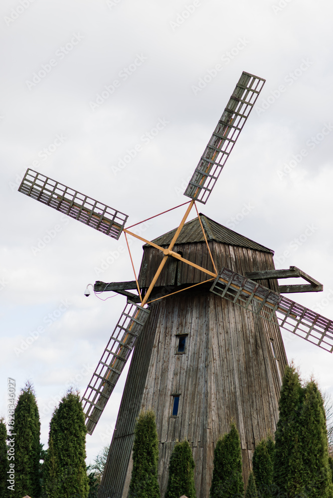 Old wooden wind mill in on a sunny day. Old traditional Dutch mill.