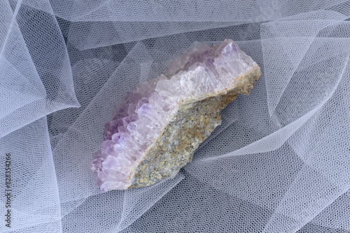 Set of various amethyst natural mineral stones and gemstones on grey fabric background