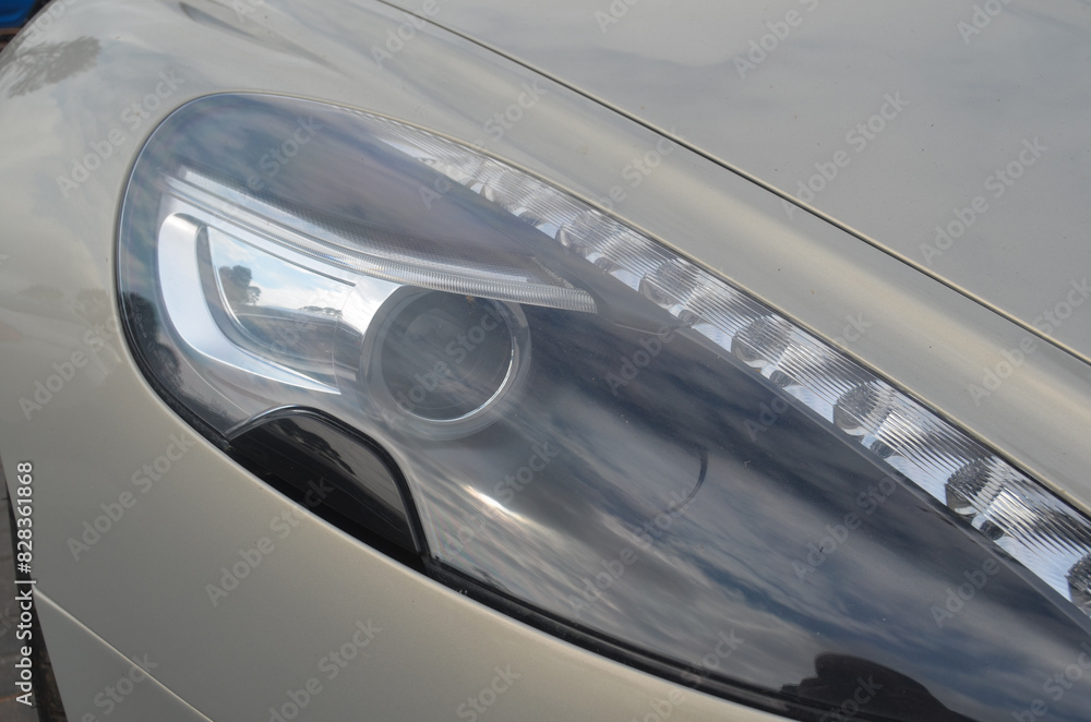 Fototapeta premium Car headlight close-up. Luxury vehicle detail of headlight.