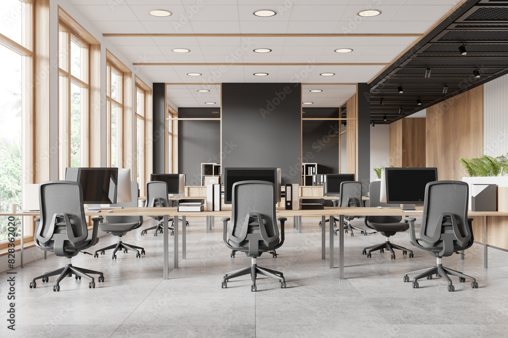 Modern office space with desks and chairs, natural light from windows, gray and wooden design. Concept of workplace. 3D Rendering
