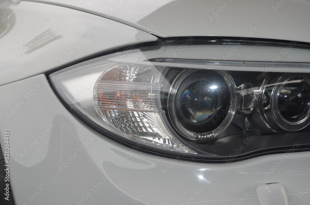 Car headlight close-up. Luxury vehicle detail of headlight. Car headlight close-up. Luxury vehicle detail of headlight.
