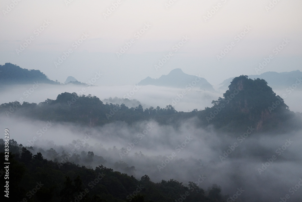 Beautiful sunrise in morning sky with mist and foggy in valley of layer mountain in natural and travel destination in tropical rain forest Beautiful sunrise in morning sky with mist and foggy in valley of layer mountain in natural and travel destination in tropical rain forest