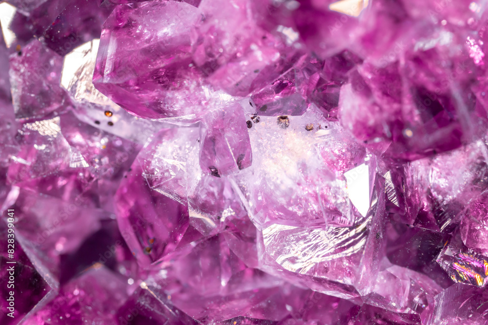 Amethyst purple crystals. Gems. Mineral crystals in the natural environment. Texture of precious and semiprecious stones. Seamless background with copy space colored shiny surface of precious stones. Amethyst purple crystals. Gems. Mineral crystals in the natural environment. Texture of precious and semiprecious stones. Seamless background with copy space colored shiny surface of precious stones.
