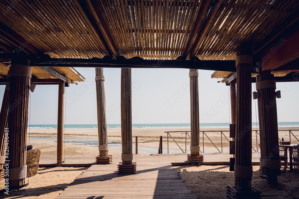 A cozy beach cafe with couch and rustic chairs