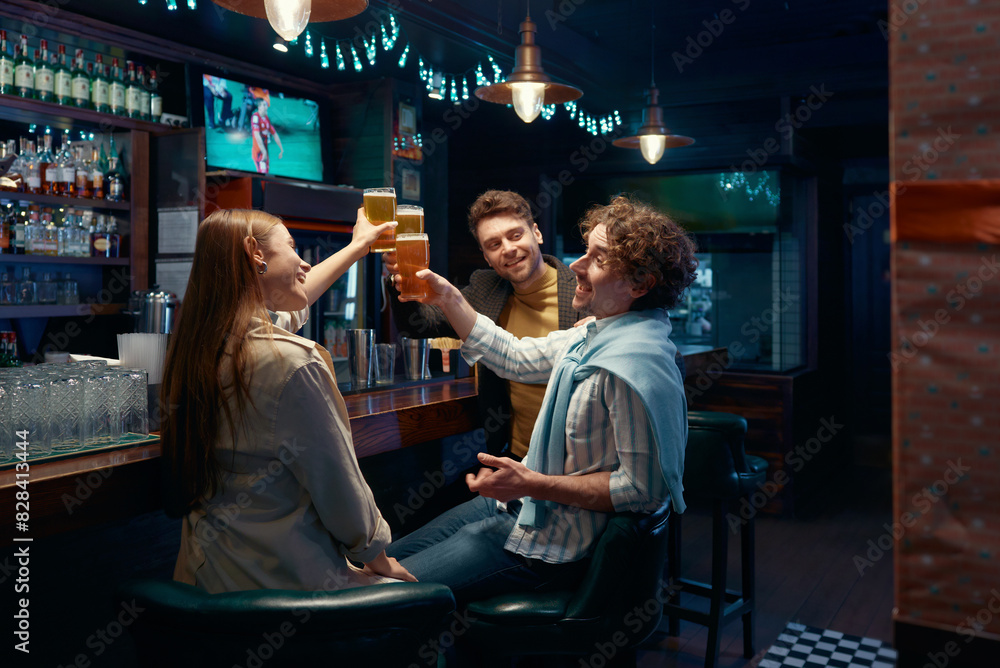 Fototapeta premium Friends employee celebrating while meeting to rest after work in bar