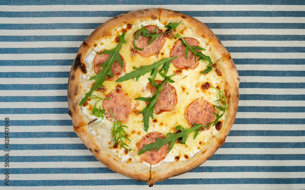 Pizza with sausage, cheese and arugula. Spring menu. Pizzeria concept Pizza with sausage, cheese and arugula. Spring menu. Pizzeria concept