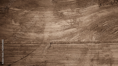 Concrete or cement texture background with wood grain and scratches with brown gradient. For backdrops, banners, walls, screens.