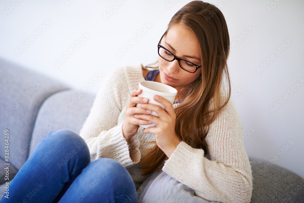 Winter, coffee and woman on sofa in home to enjoy caffeine, espresso or cappuccino in living room. Peace, tea cup and female person in lounge drinking warm beverage to relax in house or apartment Winter, coffee and woman on sofa in home to enjoy caffeine, espresso or cappuccino in living room. Peace, tea cup and female person in lounge drinking warm beverage to relax in house or apartment