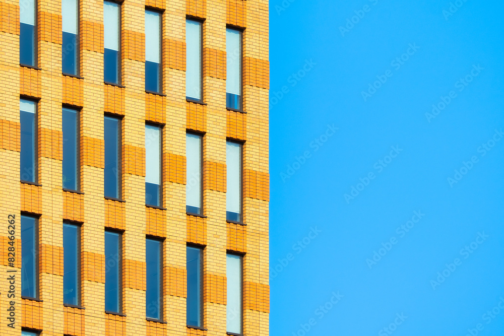A lot of windows on a skyscraper building. Urban textures and backgrounds. Modern architecture and design. Building details.