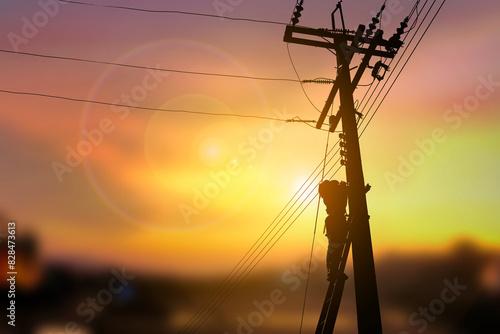 A technician work on high electricity pole silhouette style