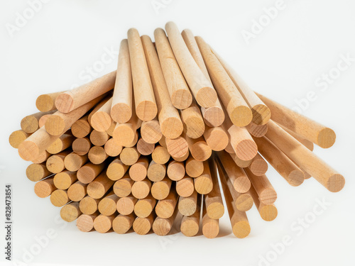 stack of hardwood dowel rods pins for crafting and woodworking