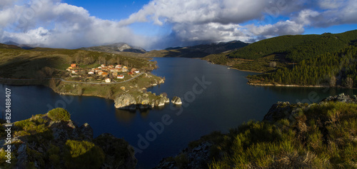 Beautiful panoramic landscape of mountain village on the slope of a swamp. Rural town of Alba de los Cardaños next to the Camporredondo Reservoir in Palencia, Spain