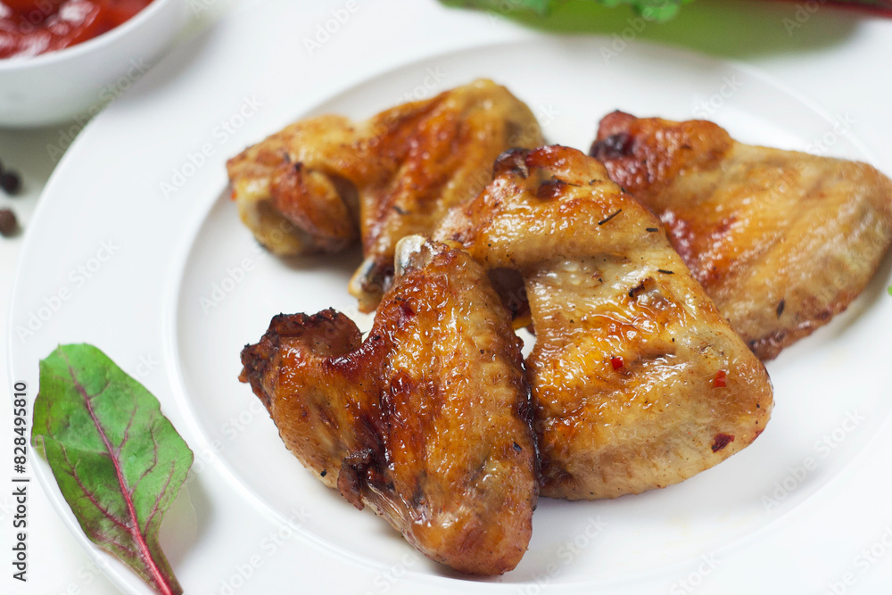 Fried chicken wings in a plate on the table Fried chicken wings in a plate on the table