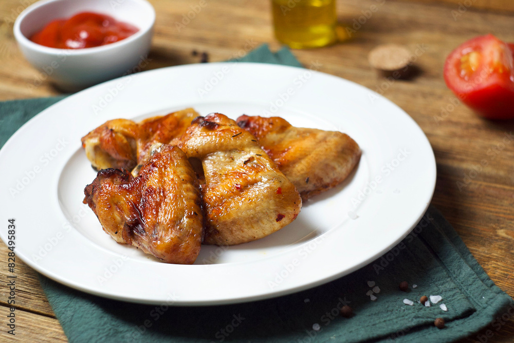 Fried chicken wings in a plate on the table Fried chicken wings in a plate on the table