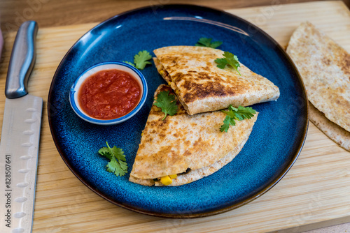 Blue plate with quesadillas with tofu and sweet corn