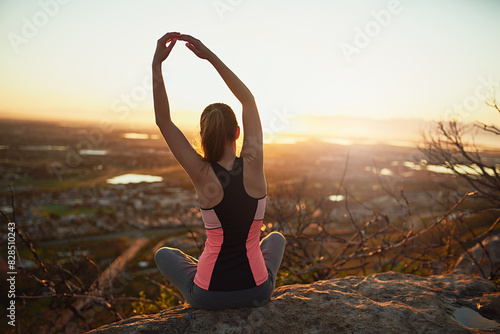 Woman, stretching and yoga on mountain in nature with back for warm up, meditation or fitness with sunrise. Yogi, pilates or person outdoor for exercise, posture or balance with lens flare or scenery