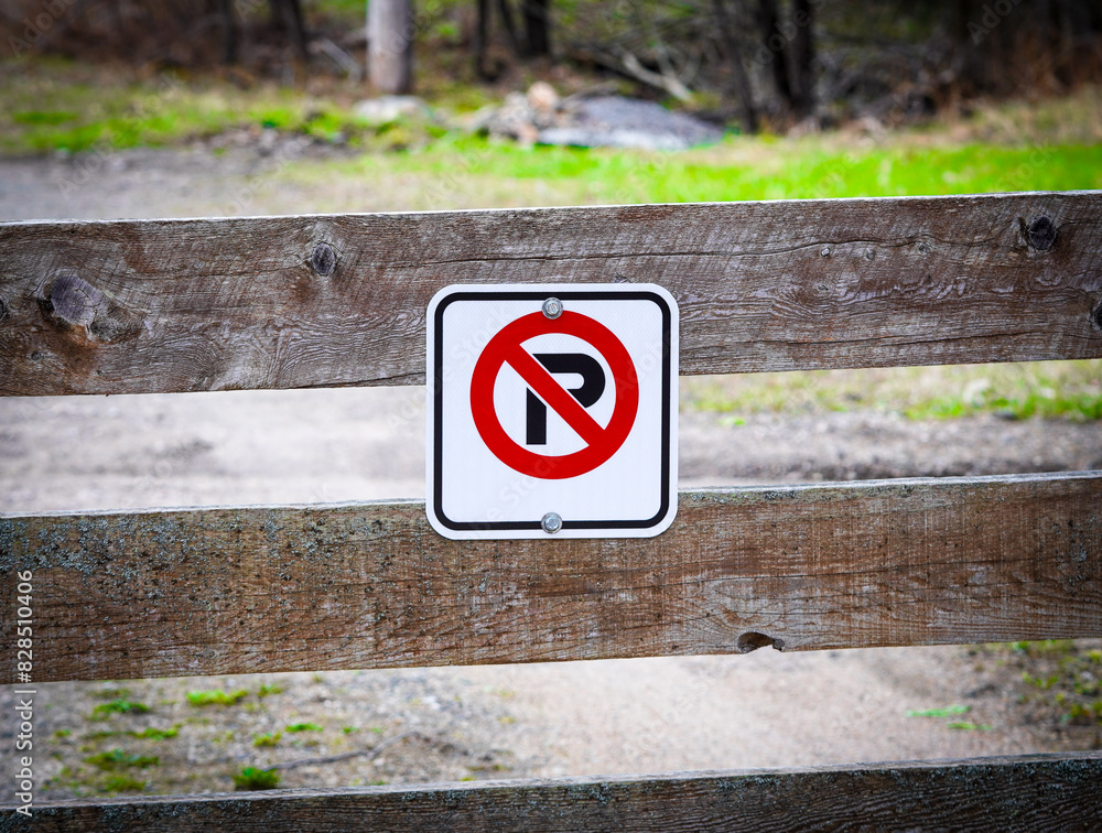 no parking sign with arrows on the top of it in the middle of a path no parking sign with arrows on the top of it in the middle of a path