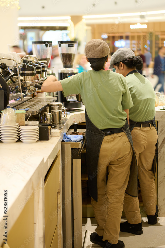 three people are preparing food on the counter in a restaurant three people are preparing food on the counter in a restaurant