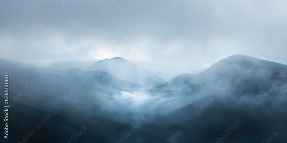 Obraz premium A blurred mountain landscape with mist rolling over the peaks, conveying a sense of mystery and grandeur.