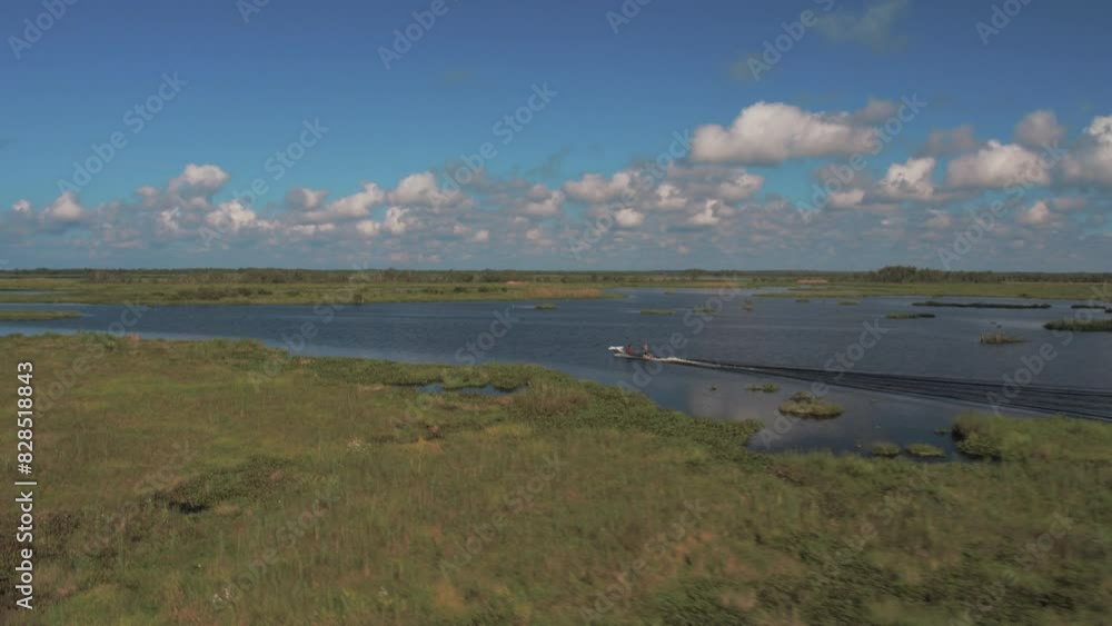 Aerial Panning Scenic View Of Motorboat Moving On Rippled River, Drone Flying Over Green Landscape During Sunny Day - Bayou Vista, Texas Aerial Panning Scenic View Of Motorboat Moving On Rippled River, Drone Flying Over Green Landscape During Sunny Day - Bayou Vista, Texas