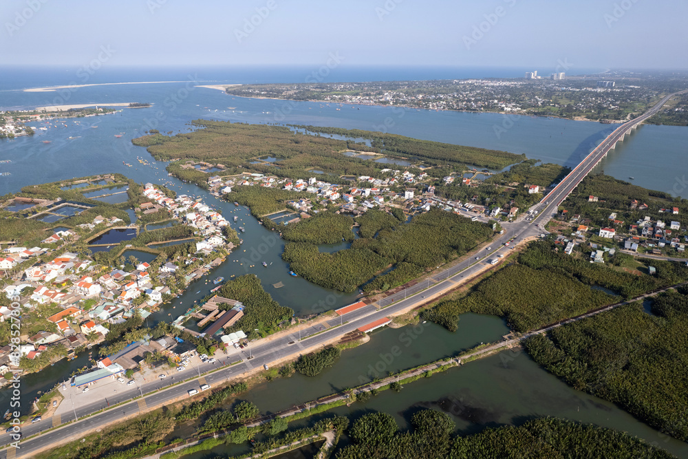 Aerial view of Thu Bon river delta and the bridge over the river on sunny day. Hoi An, Vietnam.