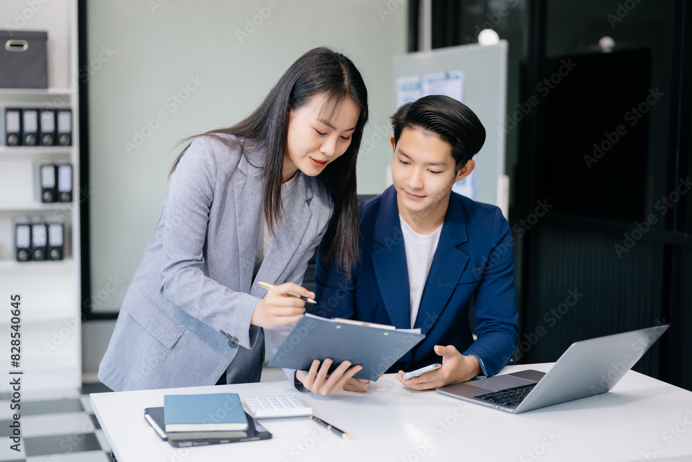 Portrait of success business people working together in office. Couple teamwork startup concept. Portrait of success business people working together in office. Couple teamwork startup concept.