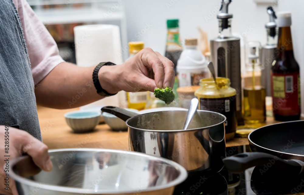 Chef at the kitchen preparing lentils soup with cauliflower and broccoli Chef at the kitchen preparing lentils soup with cauliflower and broccoli