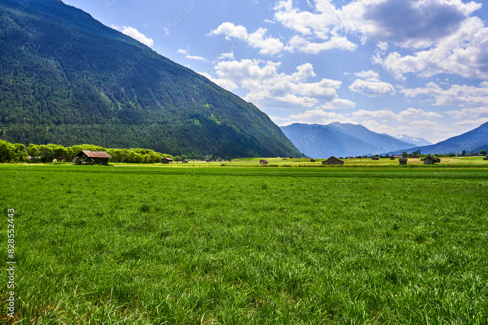 a large open field surrounded by mountains in the background from an iphone a large open field surrounded by mountains in the background from an iphone