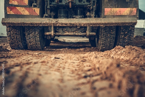 Canvas Print Closeup shot of a truck working on the field all covered in mud