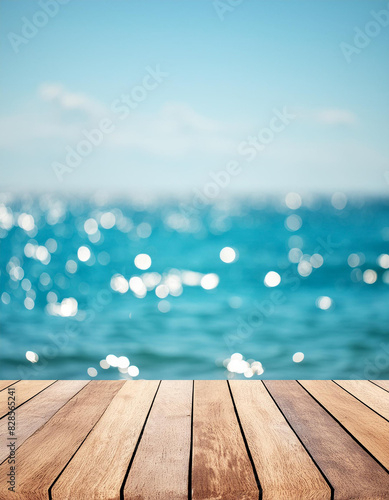 Wood table top on blur sparkling sea water and summer sky background