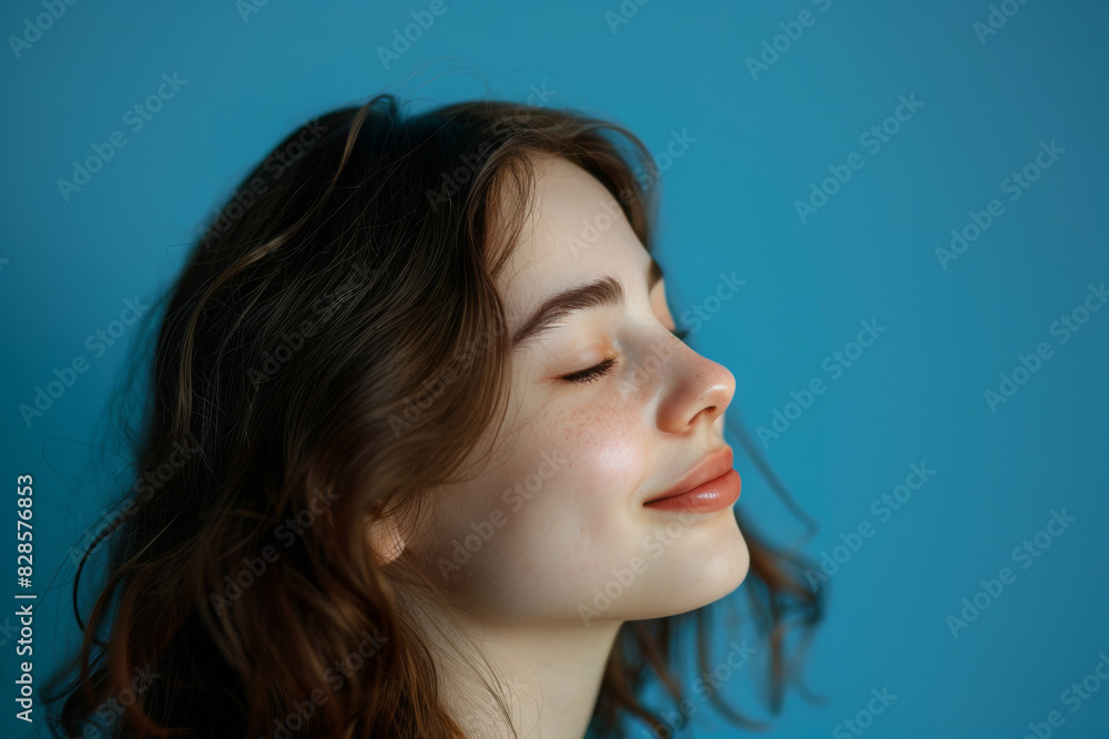 A close up of a woman's face with her eyes closed looking to a side A close up of a woman's face with her eyes closed looking to a side