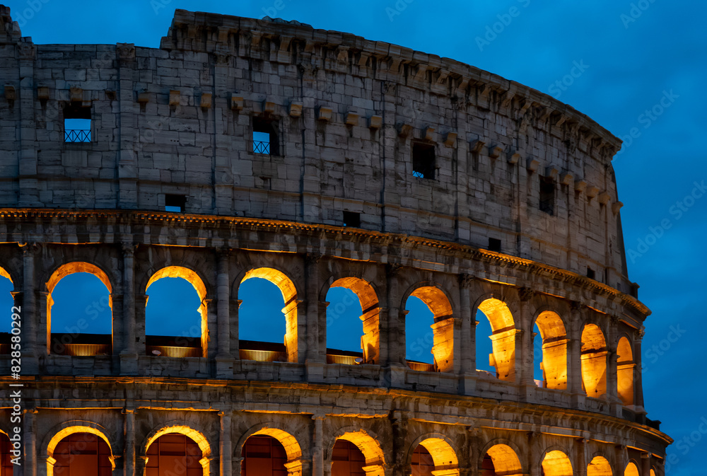 the colosseum in rome is lit up at night