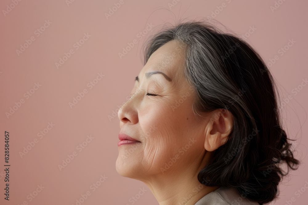 A close up of a woman's face with her eyes closed looking to a side A close up of a woman's face with her eyes closed looking to a side