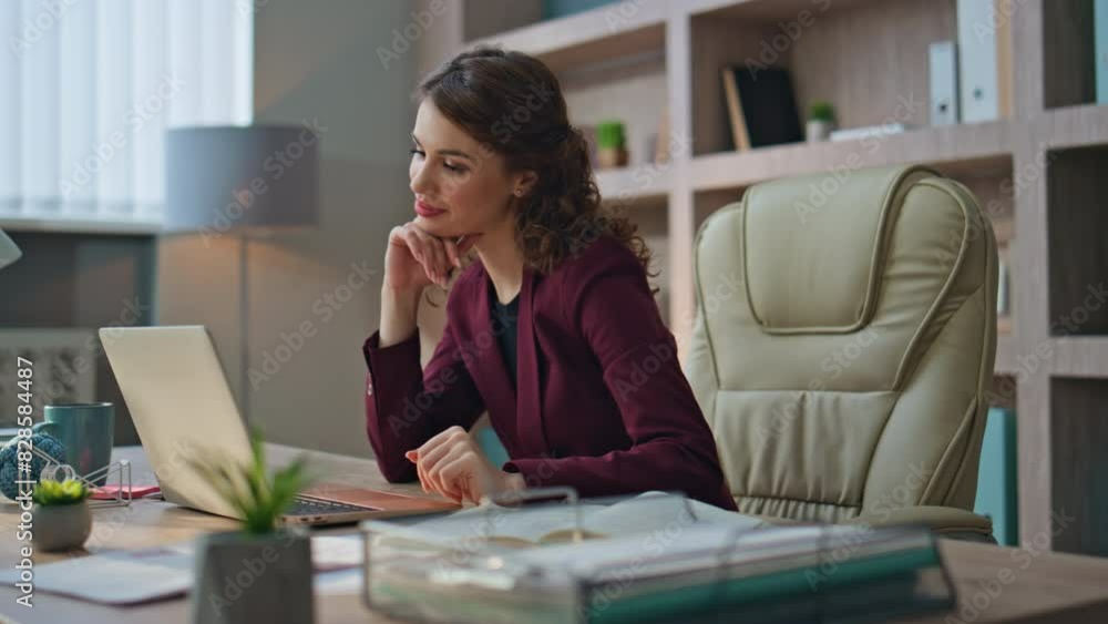 Successful entrepreneur working computer at desk. Smiling manager typing report