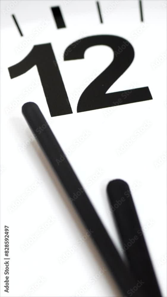 White Clock Measuring Seconds And Minutes. The Time On The Clock Twelve. Vertical. White Clock Measuring Seconds And Minutes. The Time On The Clock Twelve. Vertical.