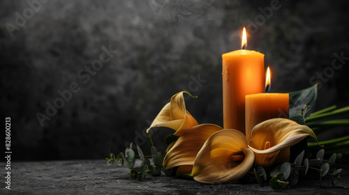 Burning candles and calla flowers on a black background, funeral concept
