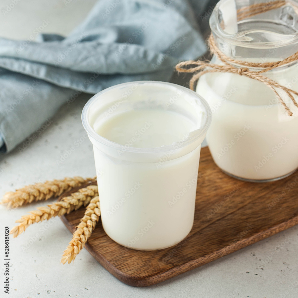 Creamy natural yogurt in a simple white container, perfect for a healthy and nutritious snack. Creamy natural yogurt in a simple white container, perfect for a healthy and nutritious snack.
