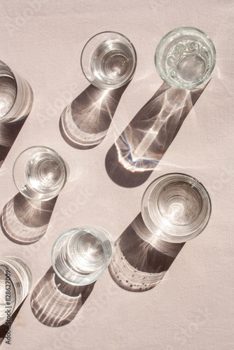 Glasses with water and contrasting shadows. Lifestyle. View from above