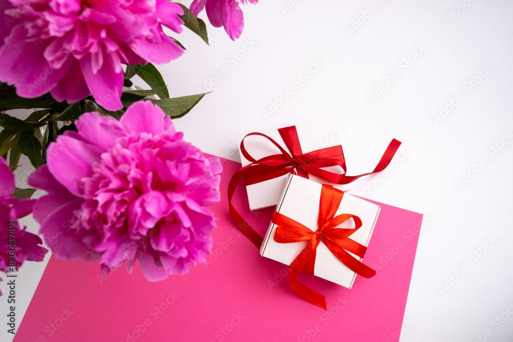 Pink peonies flowers, gift box on a colored background. Congratulations on the holiday, Women's Day, birthday or Mother's Day Pink peonies flowers, gift box on a colored background. Congratulations on the holiday, Women's Day, birthday or Mother's Day