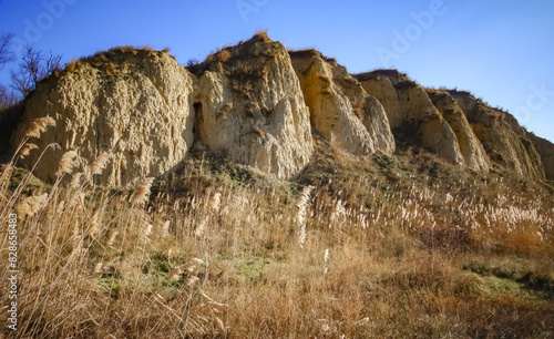 Clay cliffs of the shore of Lake Yalpug against the background of a blue sky photo