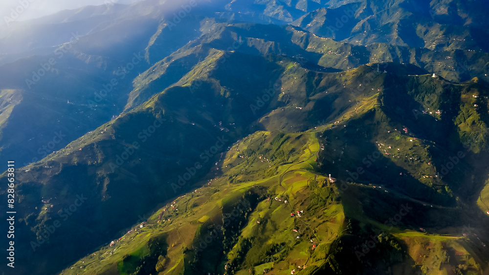 View of the rural houses of the Turks scattered over the green mountains from the window of an airplane in Turkey View of the rural houses of the Turks scattered over the green mountains from the window of an airplane in Turkey