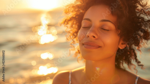 Tranquil woman with closed eyes enjoying the soothing light of a sunset by the sea