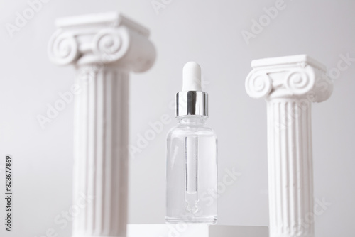 Cosmetic bottle on podium and roman column on grey background. Creative product stage mock up, cosmetic display podium platform or cosmetics product presentation, geometric stand with stylish props.