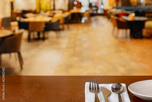Restaurant interior with silverware on table. Service industry jobs, employment, and dining concept.