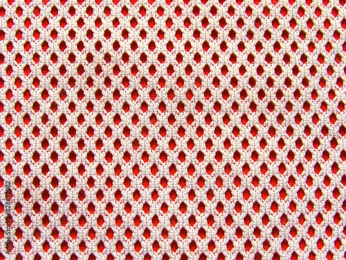Handmade crochet cloth mesh pattern texture. Background fabric crochet mesh cloth white red textile. Detail close up pattern background white red fashion cloth mesh holes. Crochet dots lace wallpaper