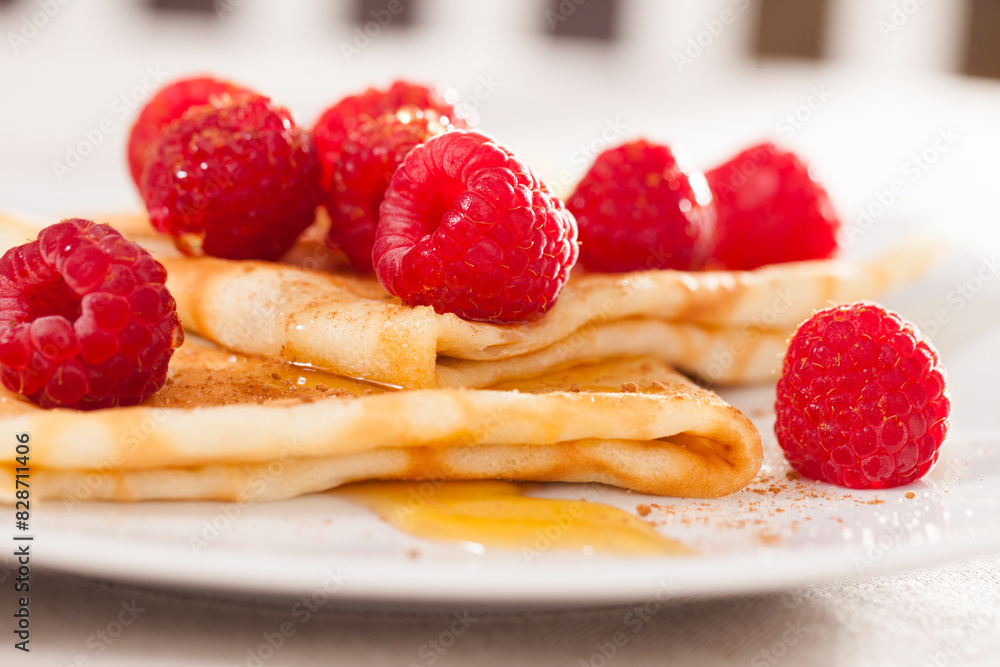 Delicious pancakes with fresh raspberries and honey Delicious pancakes with fresh raspberries and honey
