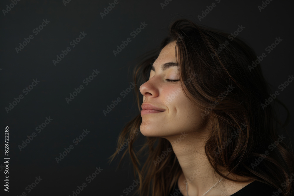 A close up of a woman's face with her eyes closed looking to a side A close up of a woman's face with her eyes closed looking to a side