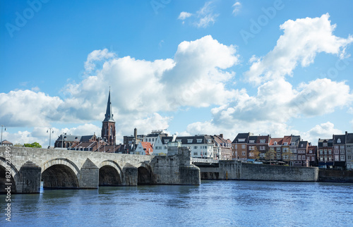 Riverfront view of classic stone bridge over Meuse in Maastricht photo