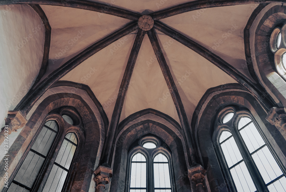 looking up at the ceiling of a church with arched windows